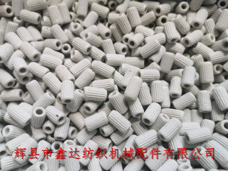 Ceramic eyes for weaving machine shuttle